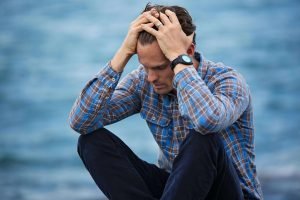 A person reflecting, symbolizing depression symptoms and mental health challenges.